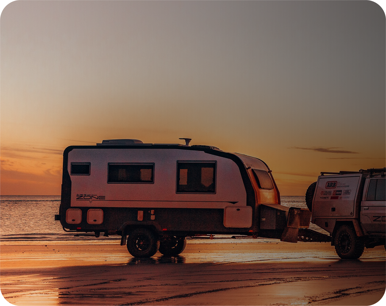 picture of a caravan on the beach during sunset